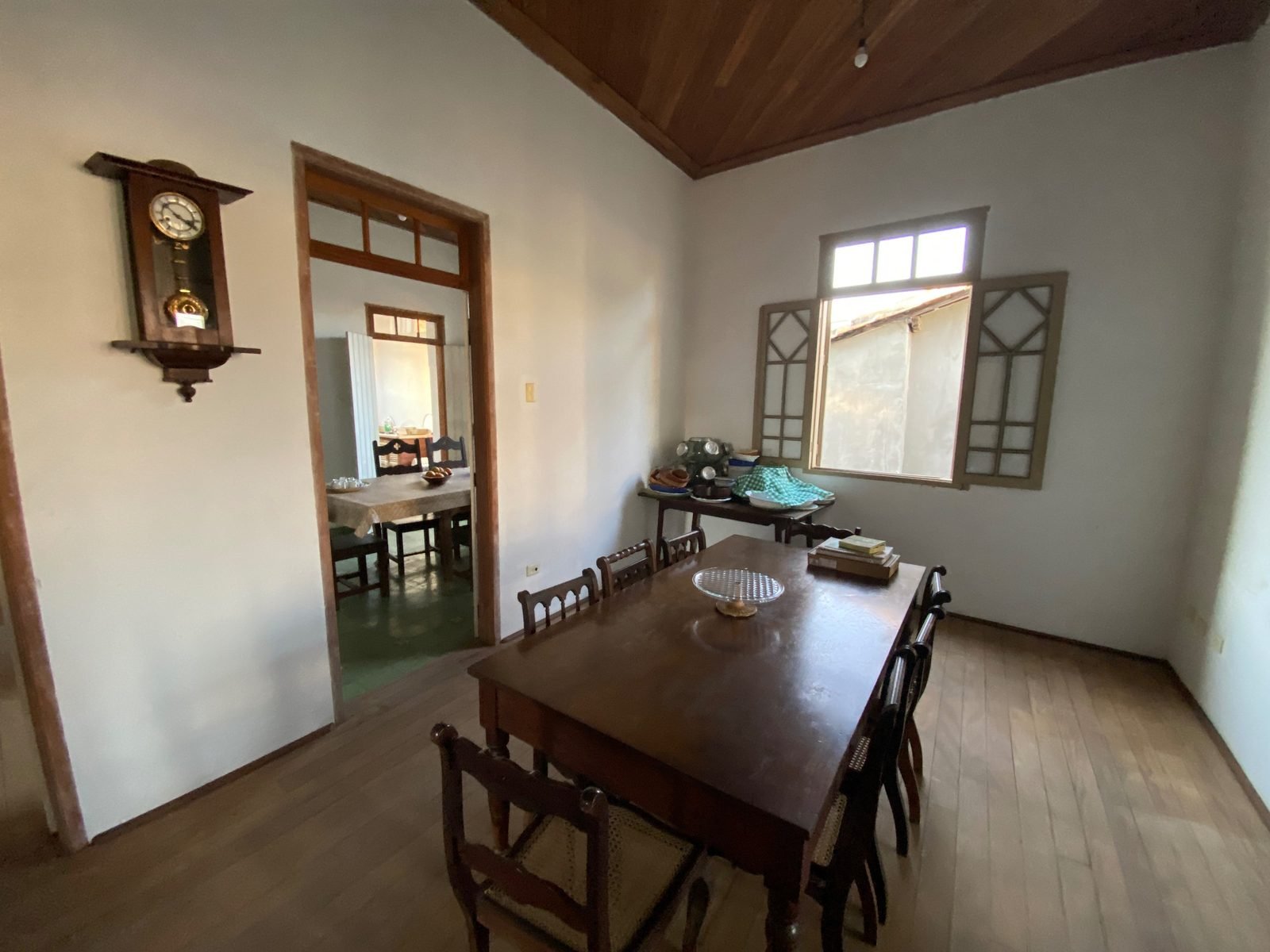 Dining room with solid wood table and wall clock